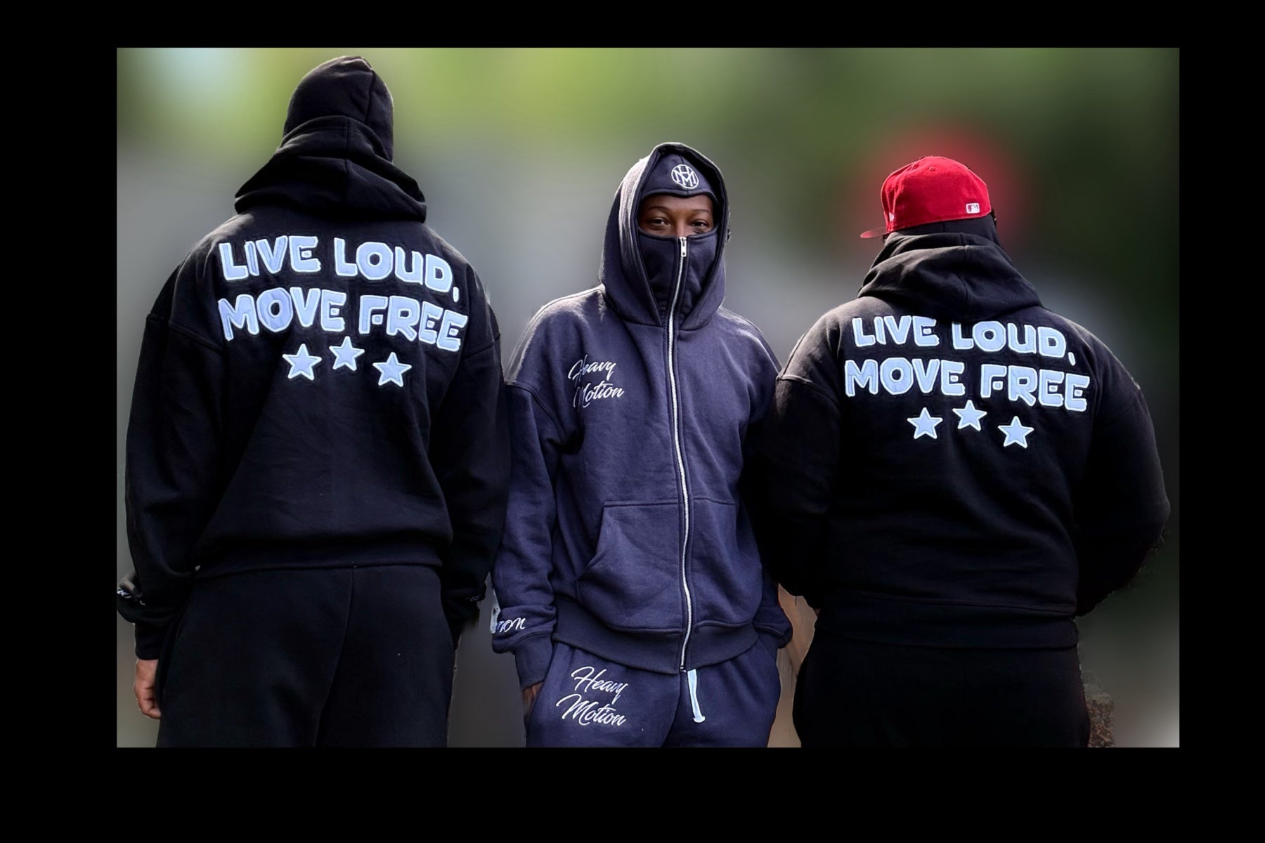 Three people wearing hoodies with text and branding.
